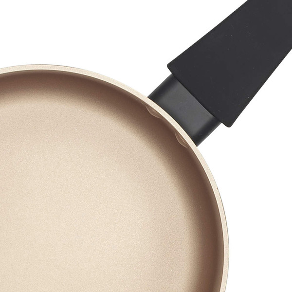 Cream non-stick frying pan, close-up showing interior surface and black handle