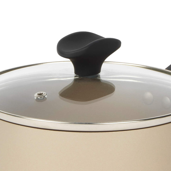 Close-up of glass lid with black handle on beige saucepan