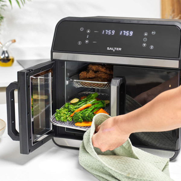 Salter air fryer oven with open door, tray of roasted vegetables being removed