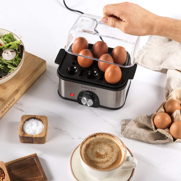 Salter egg boiler with six brown eggs on kitchen counter, lid being lifted