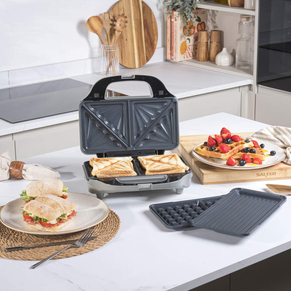 Salter 3-in-1 sandwich maker with toasted sandwiches inside, waffle and grill plates shown