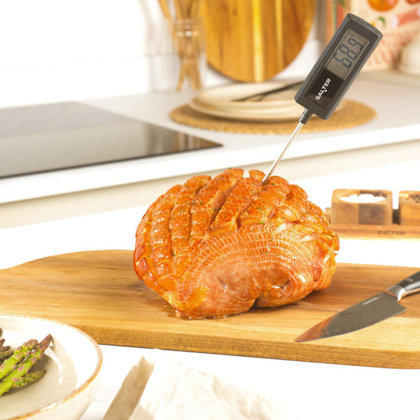 Black digital cooking thermometer with metal probe, shown side view