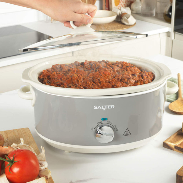 Grey Salter slow cooker filled with cooked chilli, shown in a kitchen setting.