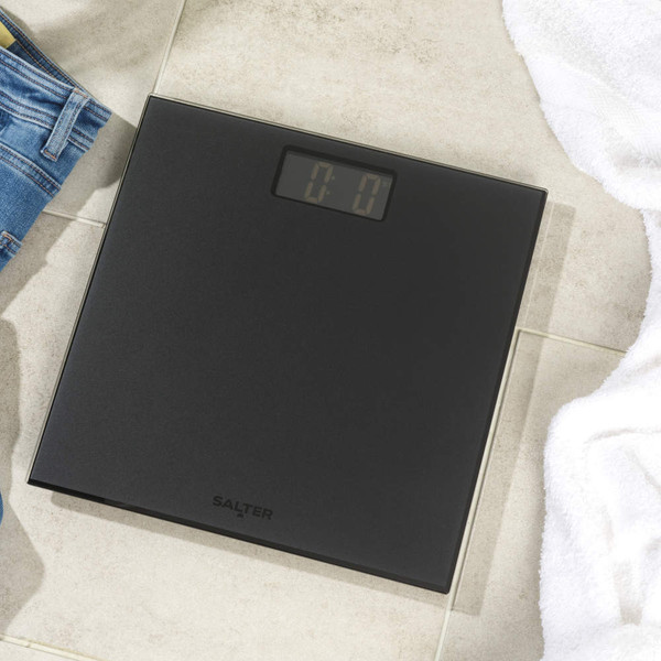 Black Salter digital bathroom scale on tiled floor