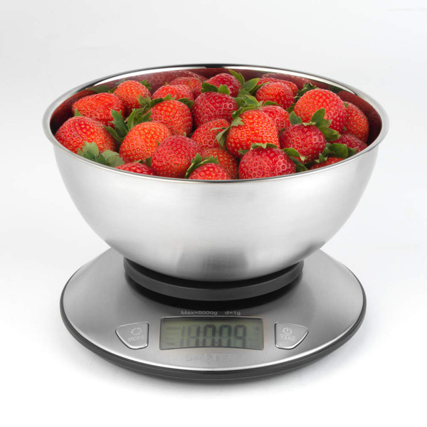 Stainless steel kitchen scale with digital display, bowl filled with fresh strawberries.