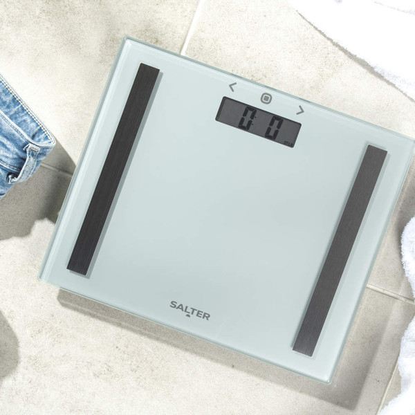 Glass bathroom scale with digital display, silver finish, Salter branding visible.