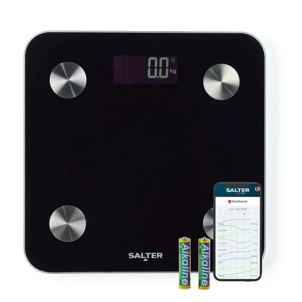 Black digital bathroom scale with visible display, batteries, and smartphone app screen.