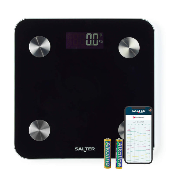 Black digital bathroom scale with visible display, batteries, and smartphone app screen.