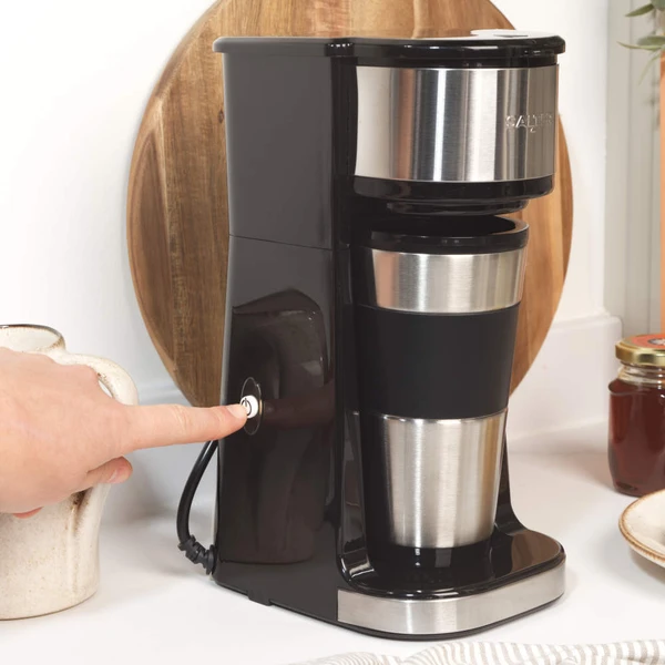 Black and silver single-serve coffee maker with stainless steel travel mug