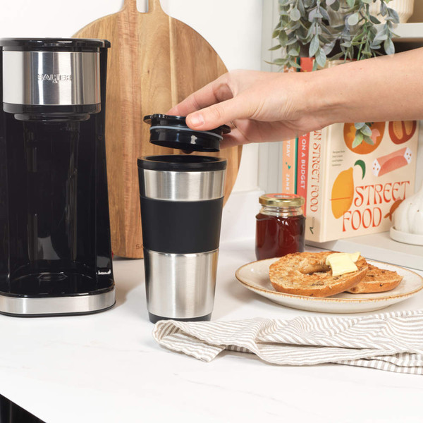 Black and silver single-cup coffee maker with travel mug, shown on white background