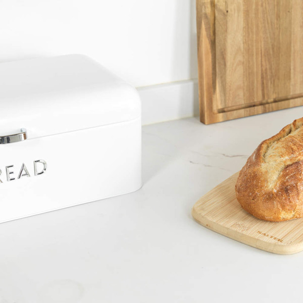 White metal bread bin with lid open, embossed 'BREAD' lettering on front.