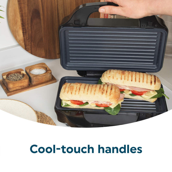 Panini press with cool-touch handles, shown open with two toasted sandwiches