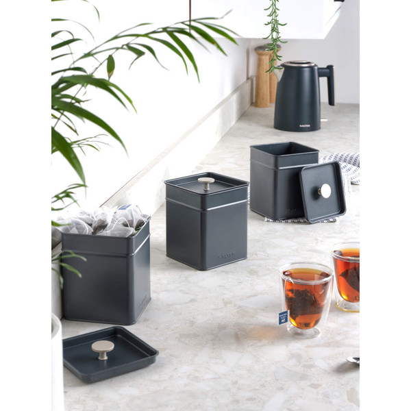 Grey metal storage canister with lid, countertop setting