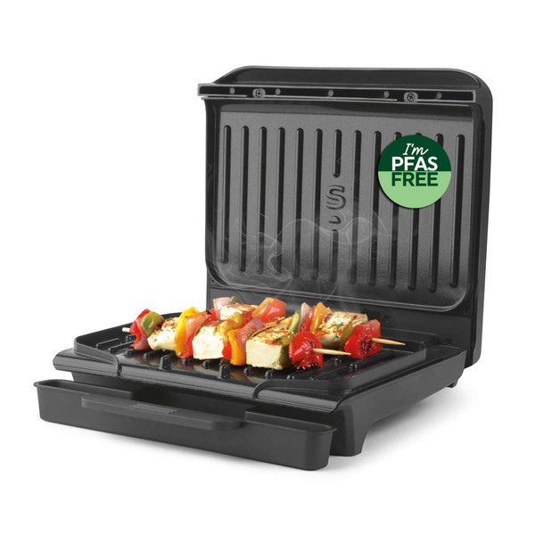 Electric grill with skewered vegetables, lid open, PFAS free badge on display
