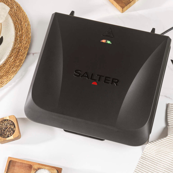 Black Salter sandwich maker closed, showing lid with indicator lights, top-down view