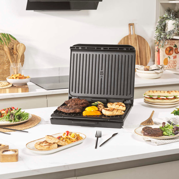 Black Salter sandwich maker closed, showing lid with indicator lights, top-down view