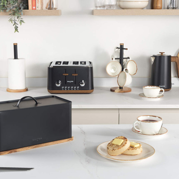 Salter matte black toaster, kettle, and bread bin on kitchen counter with cups and crumpets