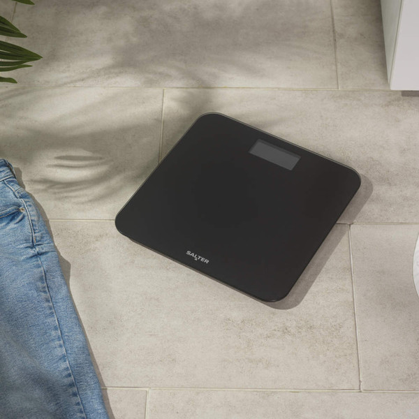Black digital bathroom scale with easy-read display and Salter logo, top view.