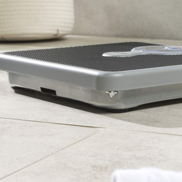 Mechanical bathroom scale with black textured platform, shown on tiled floor
