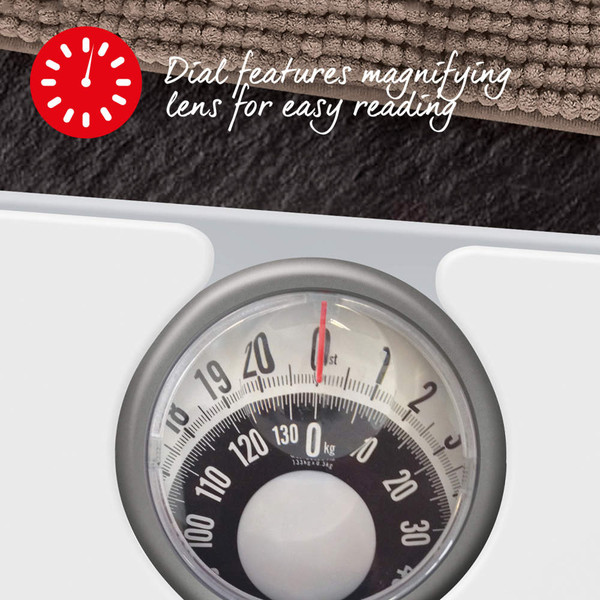 Mechanical bathroom scale with magnifying lens dial, shown close up.