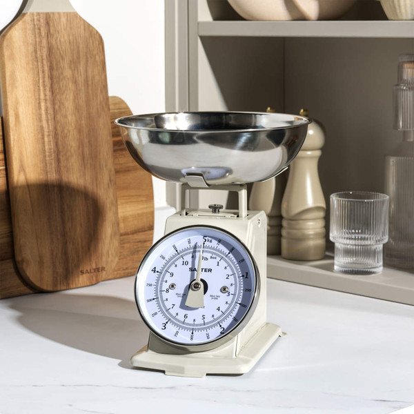 Cream kitchen scale with stainless steel bowl on countertop