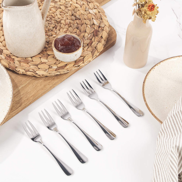 Silver dessert fork with three prongs, shown on white background