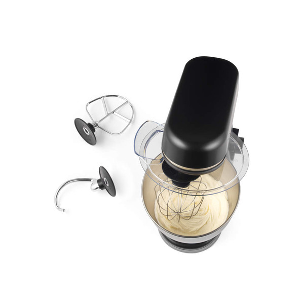 Black and gold stand mixer with whisk attachment and bowl of cake mix, top view