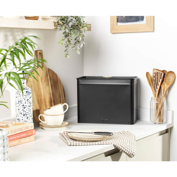 Black metal bread bin on kitchen worktop, shown in modern UK home setting