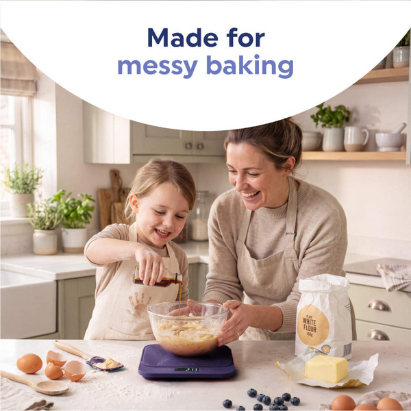 Digital kitchen scale in dark blue with display, surrounded by muffins and blueberries