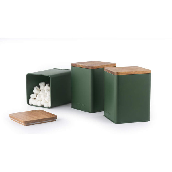 Set of three green metal kitchen storage canisters with wooden lids, one filled with sugar cubes.