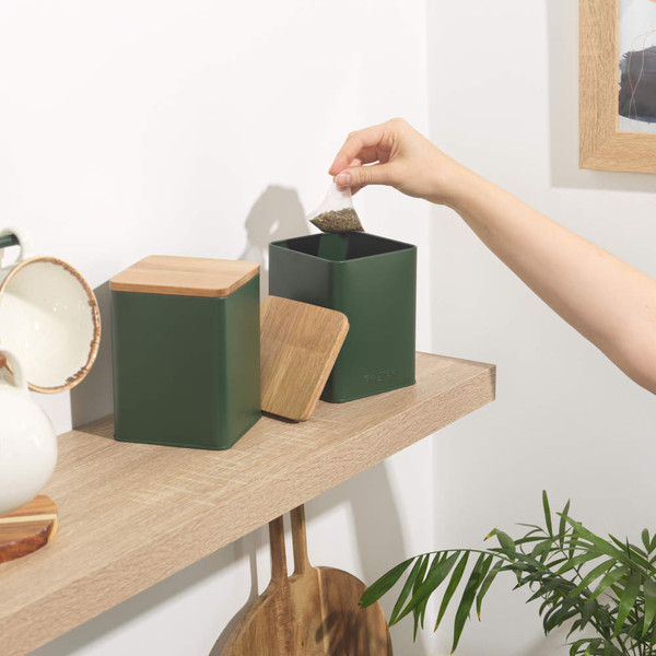 Green metal storage tin with wooden lid, front view