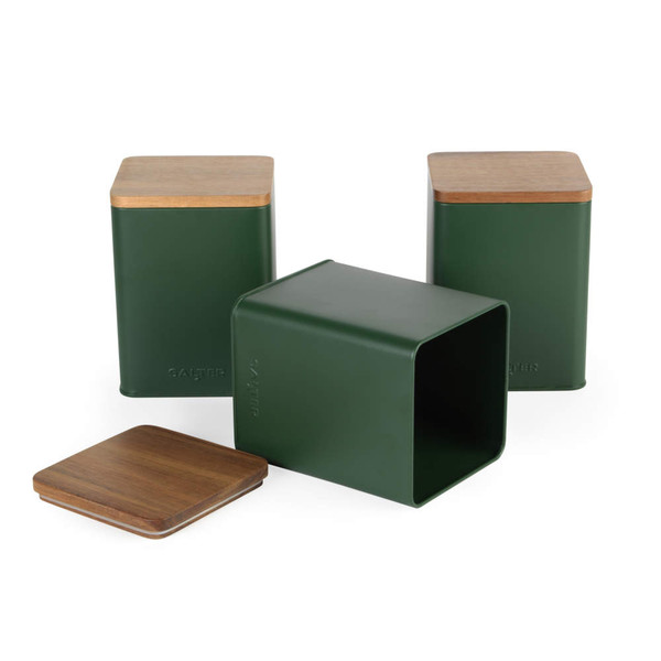 Set of three green metal storage canisters with wooden lids, one shown open