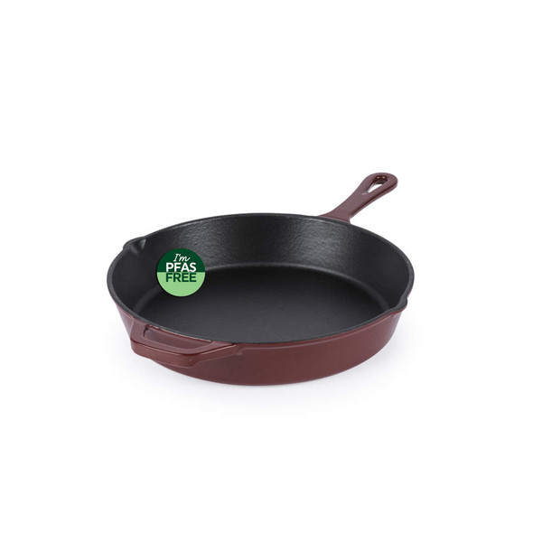 Red cast iron frying pan with PFAS free label, shown angled on white background