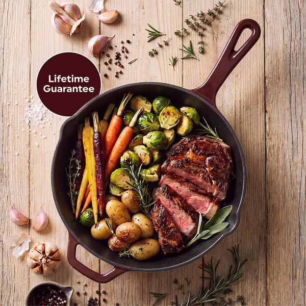 Red cast iron frying pan with cooked salmon and asparagus on wooden table
