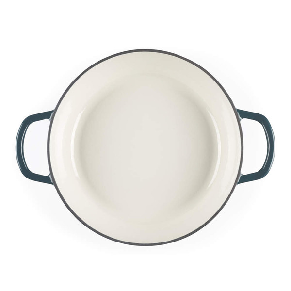 Green enamelled cast iron casserole dish, top view showing cream interior and side handles