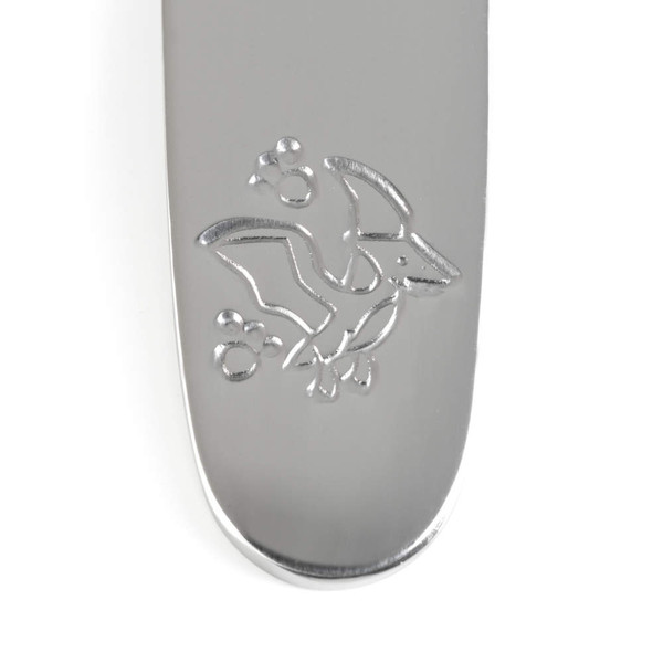 Silver utensil with engraved pterodactyl detail