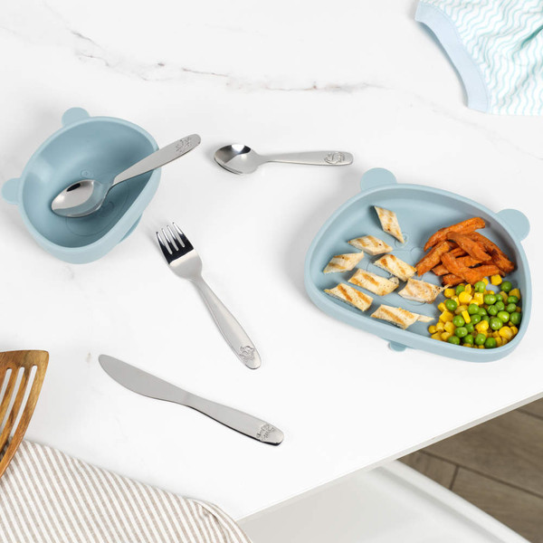 Children’s silver spoon handle with engraved dinosaur and paw prints