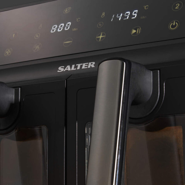 Black dual basket air fryer with digital display, shown cooking food on a kitchen counter