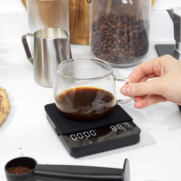 Glass coffee server with brewed coffee on digital scales