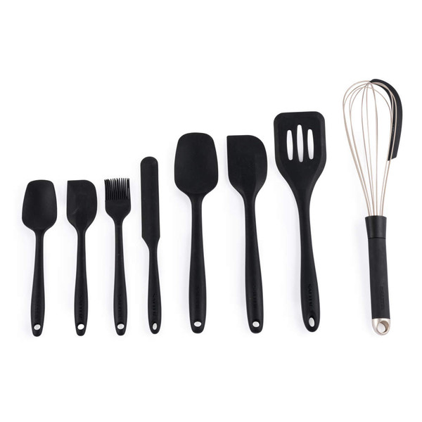 Set of eight black silicone kitchen utensils with stainless steel whisk, laid out on white background