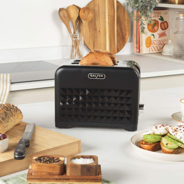 Black Salter toaster with geometric pattern, toasting two slices of bread on kitchen counter