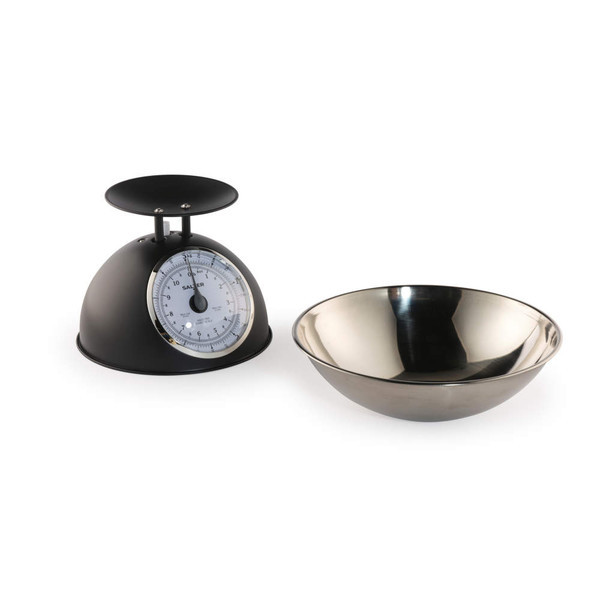 Black mechanical kitchen scale with stainless steel mixing bowl, side view