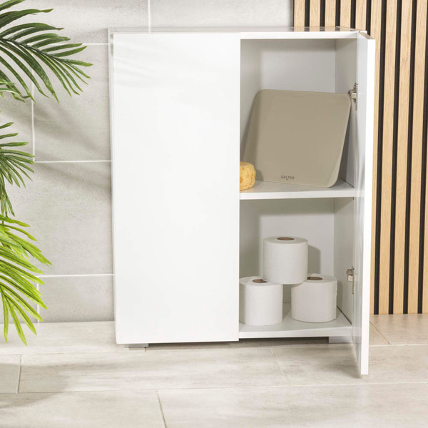 White bathroom cabinet with partially open door showing shelves with scales and toilet rolls