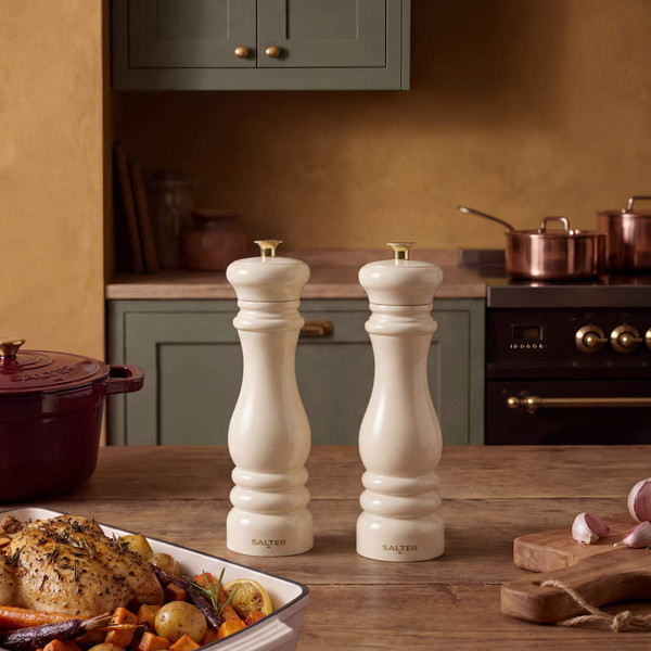 Cream salt and pepper mills on kitchen table, traditional style, set of two