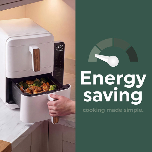 Family preparing food in a white kitchen with a white countertop appliance