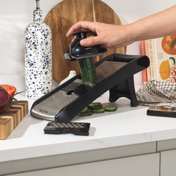 Black multi-blade vegetable mandoline slicer with attachments and food holder