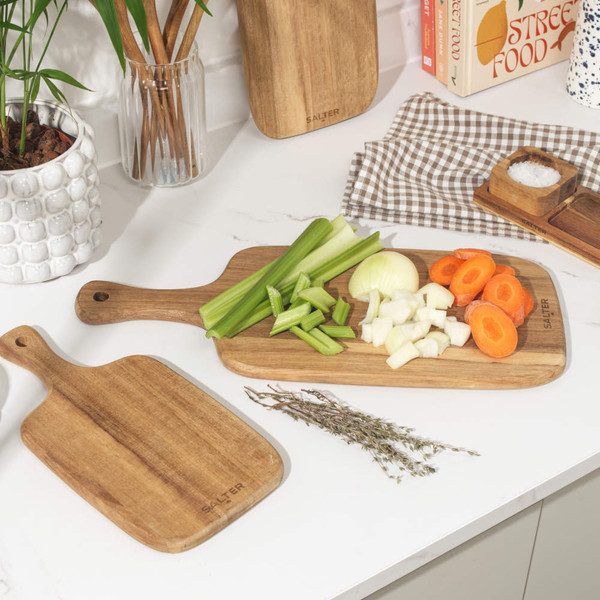 Set of three wooden paddle chopping boards, natural finish, shown upright.