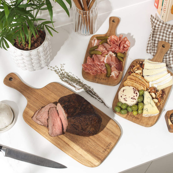 Set of three rectangular wooden chopping boards with handles, nested together