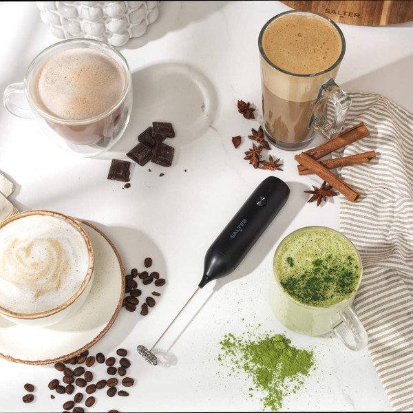 Black handheld milk frother with stainless steel whisk attachment
