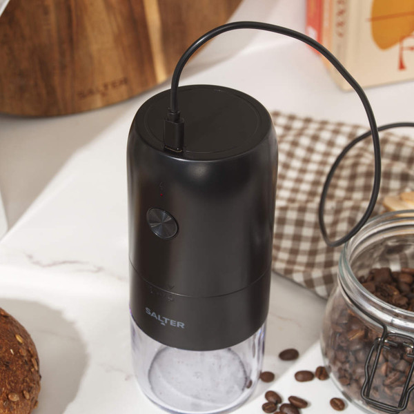 Close-up of black Salter electric grinder showing lock symbols and logo